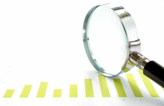 chart and a magnifying glass meeting volume