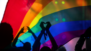 Pride rainbow flag with people silouetted