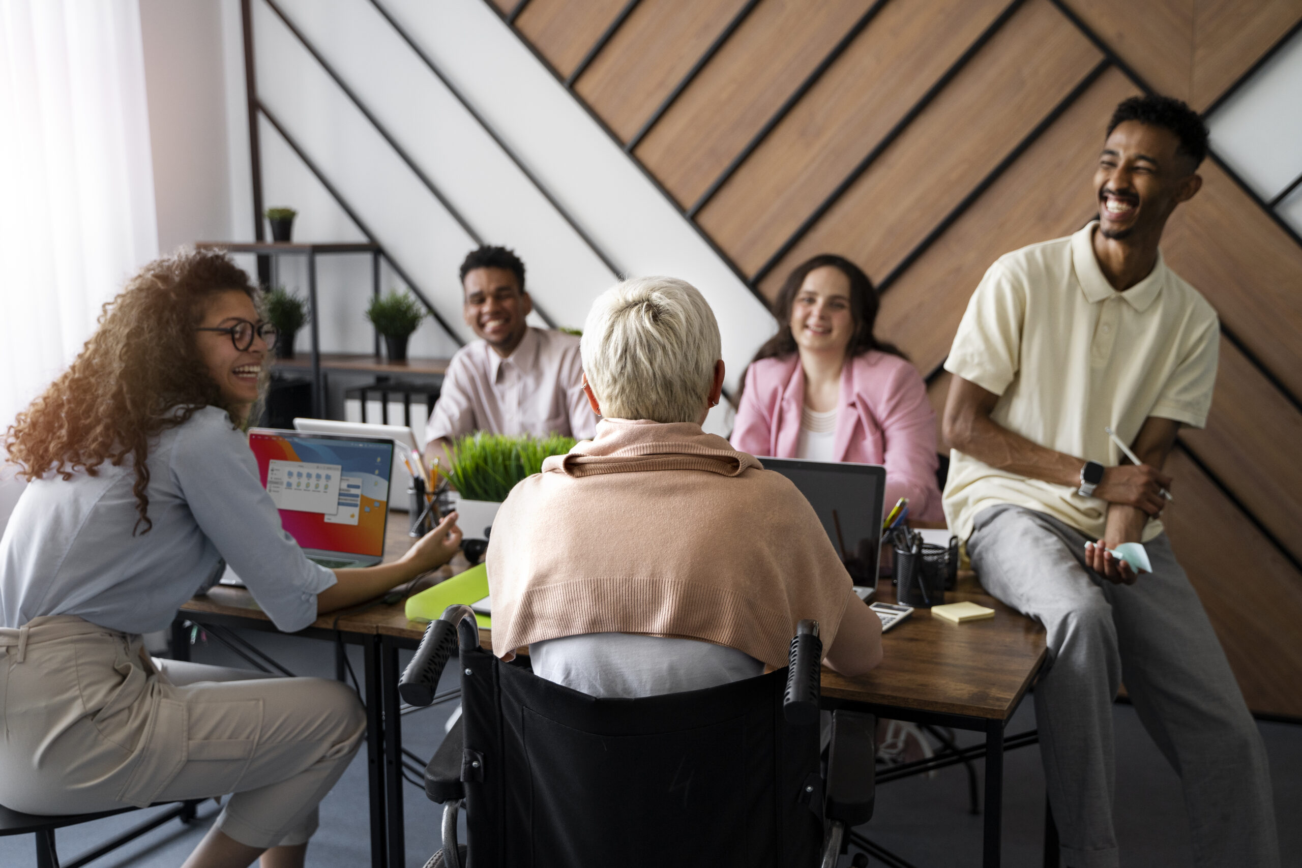 baby boomer and multigenerational group sitting around a work table