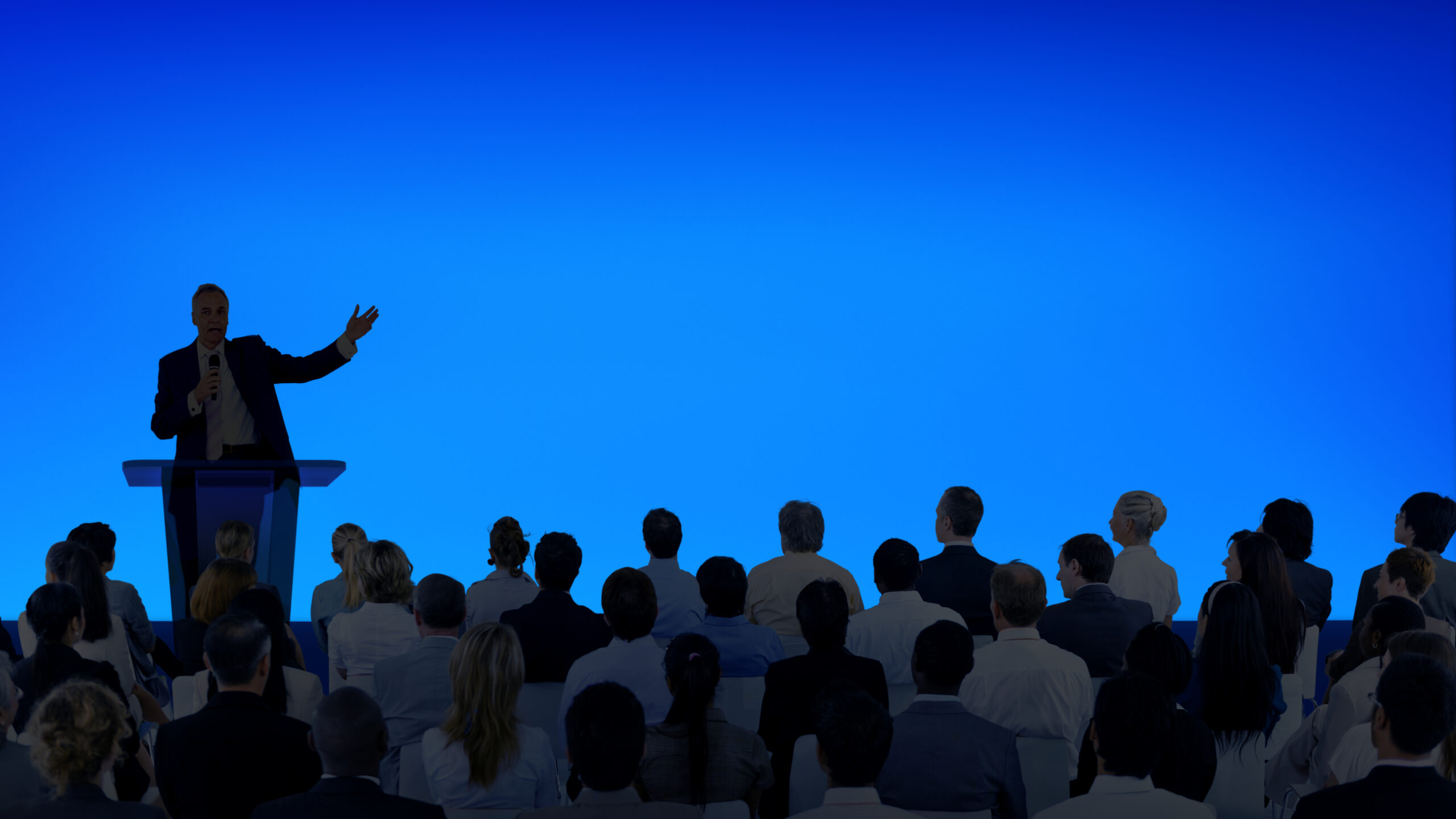 corporate speaker giving talk to large audience