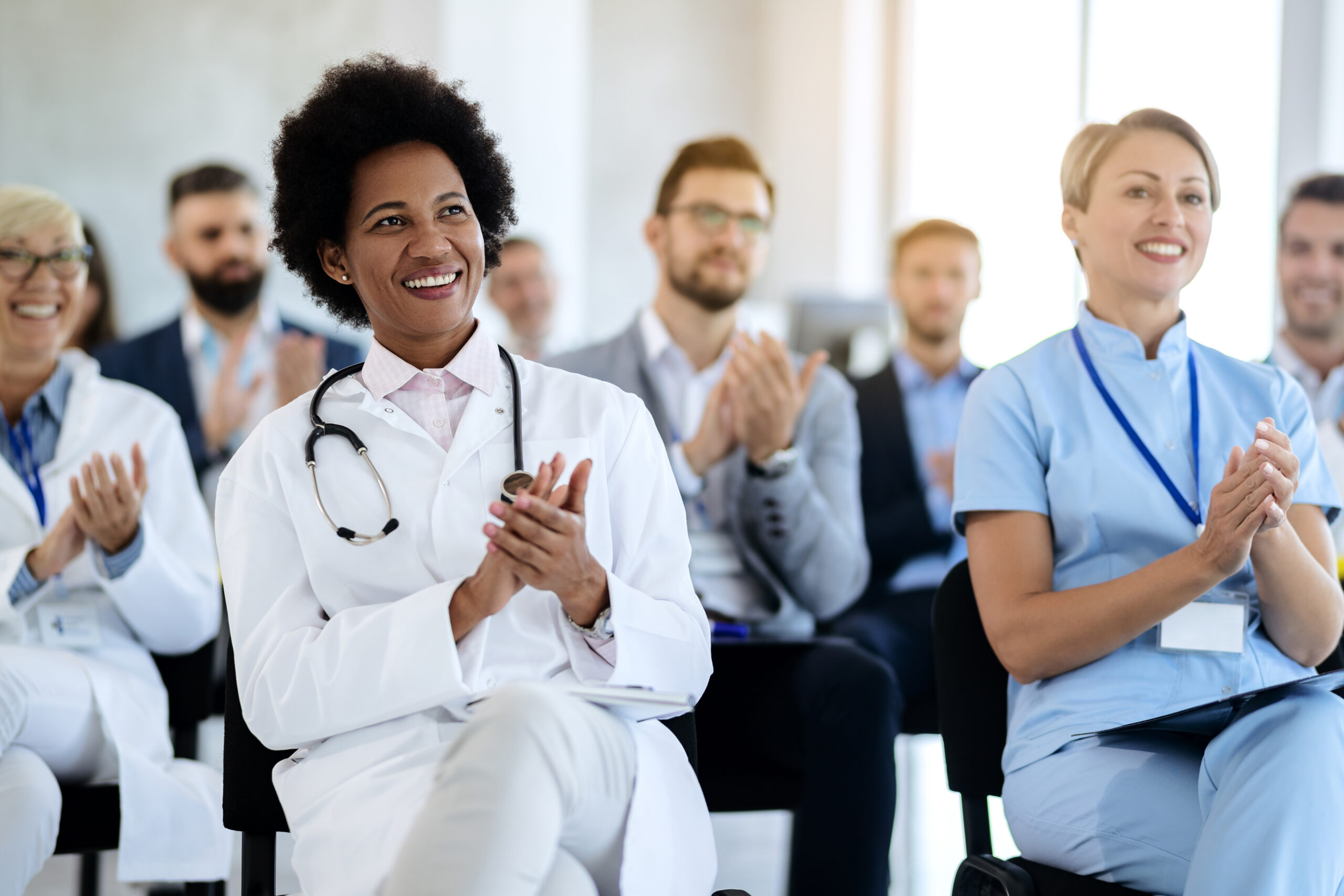 physicians applauding at a conference