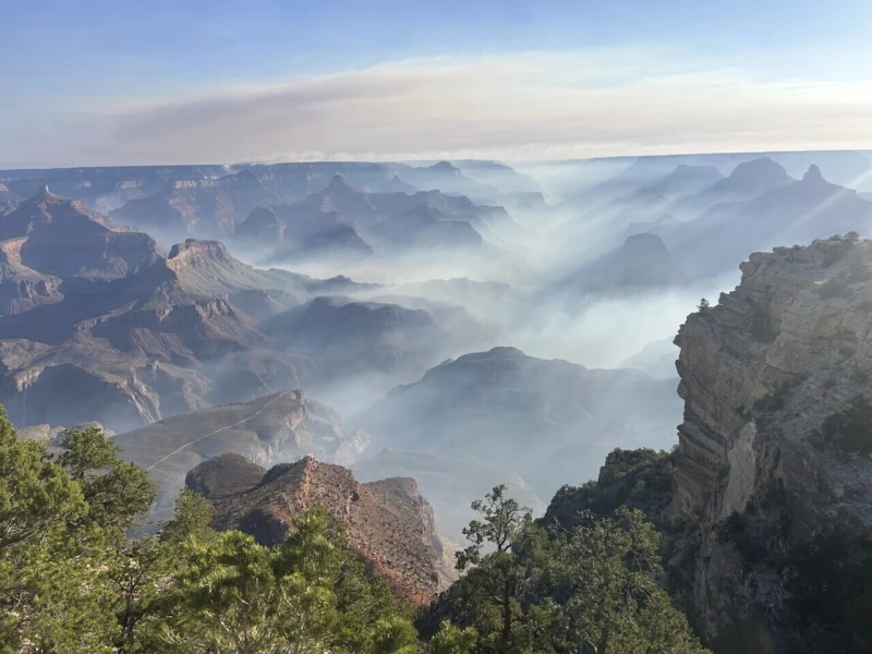 In this photo provided by the National Park Service, smoke from wildfires settles over Grand Canyon National Park in northern Arizona on Friday, July 11, 2025. (Joelle Baird/Grand Canyon National Park)
