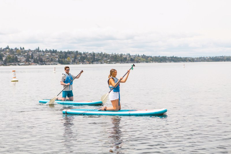 Hyatt Regency guests paddleboarding on Lake Washington.